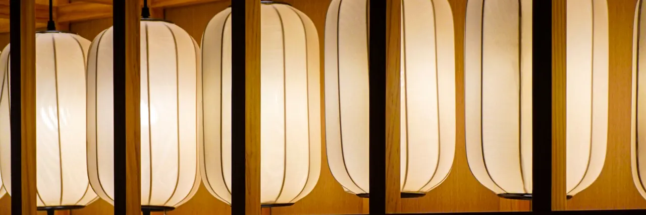 A wall of lit paper lanterns in the dining room