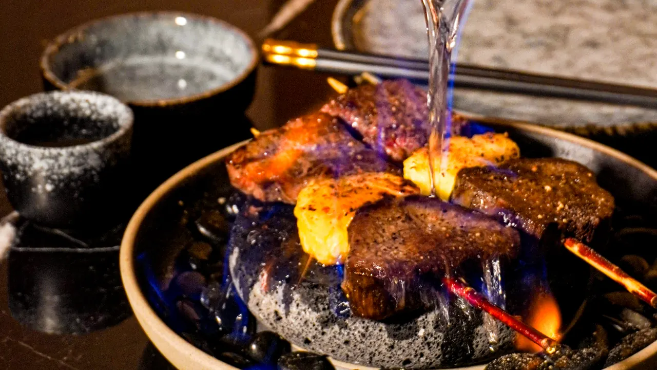 Wagyu flambéed on a hot stone at the table