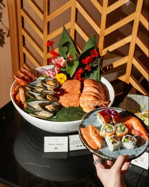 The lunch buffet: mussels, prawns and salmon sashimi on a bed of leaves, beside a plate of sushi