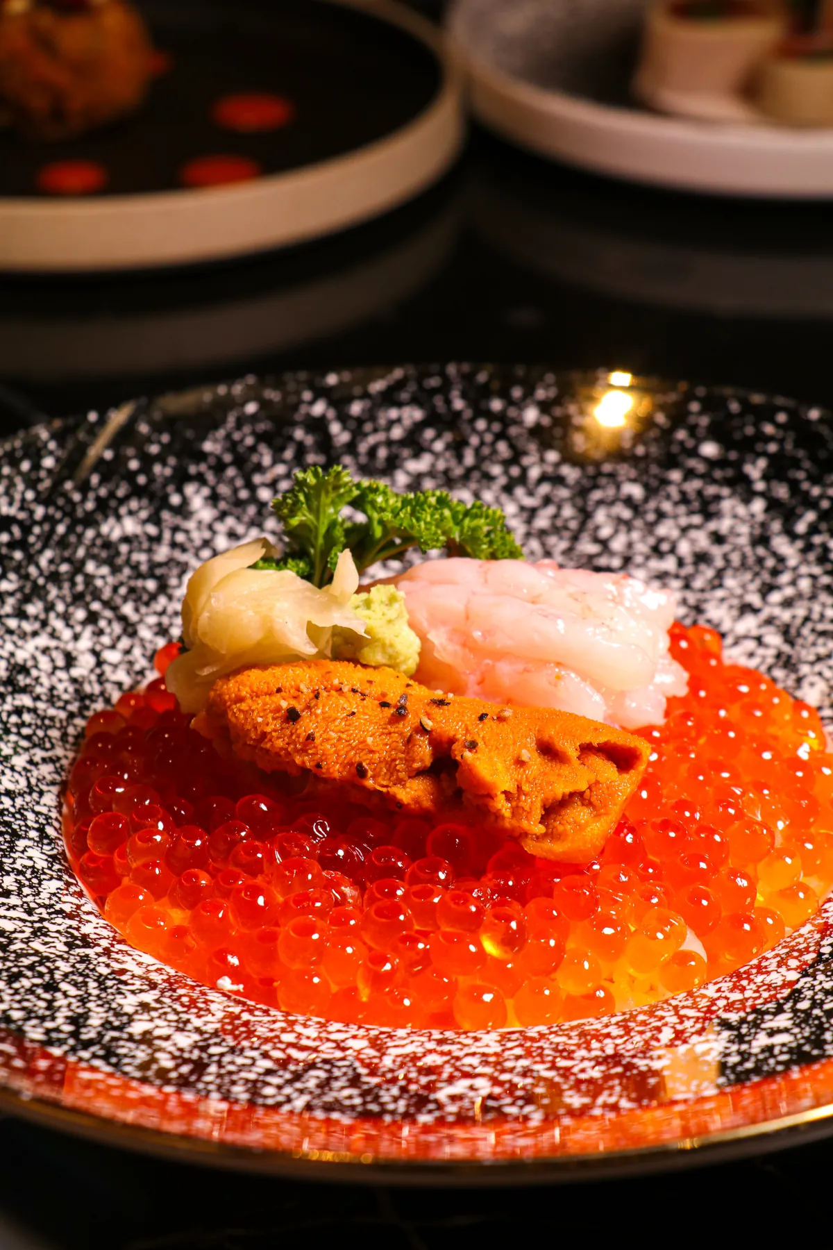 Sea urchin, sweet prawn and wasabi on a bed of salmon roe